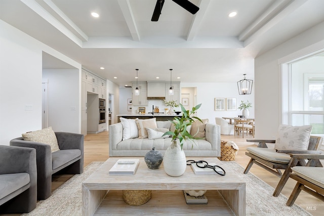 living room with recessed lighting, beamed ceiling, light wood-style flooring, and ceiling fan