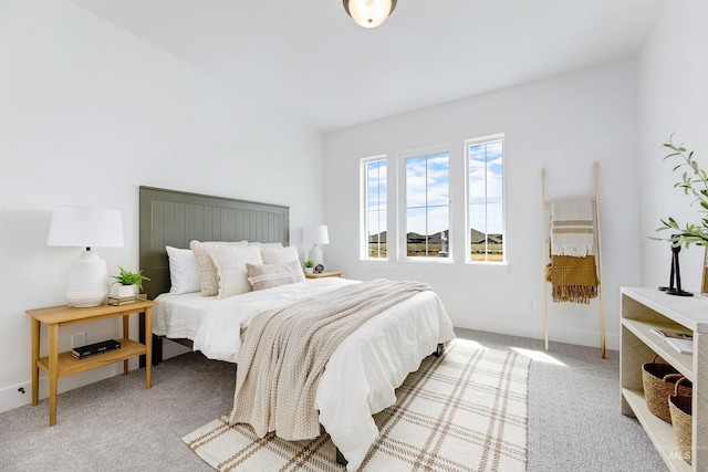 carpeted bedroom featuring baseboards