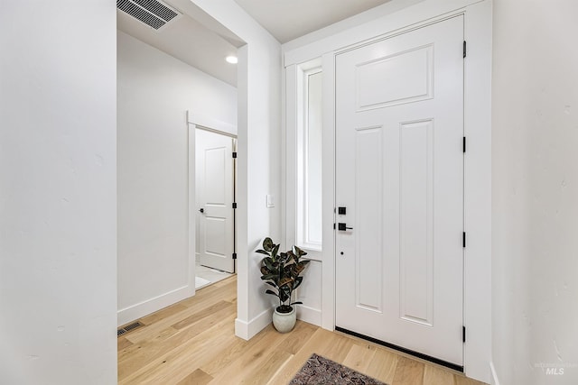 entrance foyer with visible vents, baseboards, and light wood-style floors