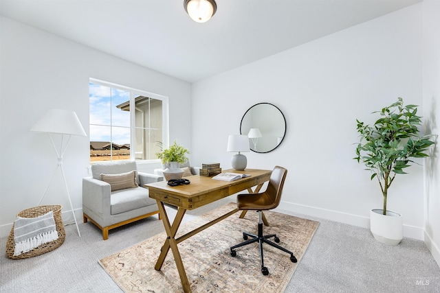 carpeted office space featuring baseboards