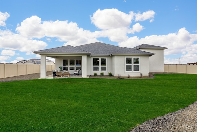 rear view of house with stucco siding, a fenced backyard, a yard, outdoor lounge area, and a patio area