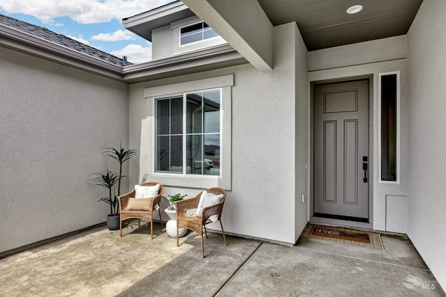 property entrance featuring stucco siding