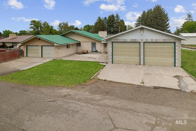 1006 S B St, Rupert, ID 83350 - view of front of property featuring a garage, a chimney, and brick siding