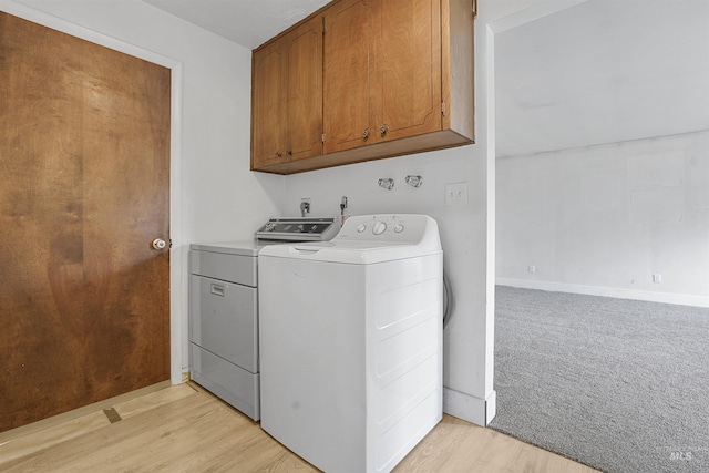1006 S B St, Rupert, ID 83350 - laundry room featuring separate washer and dryer, cabinet space, light wood finished floors, and baseboards