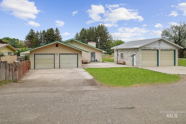 1006 S B St, Rupert, ID 83350 - view of front of house with a detached garage, brick siding, and a chimney
