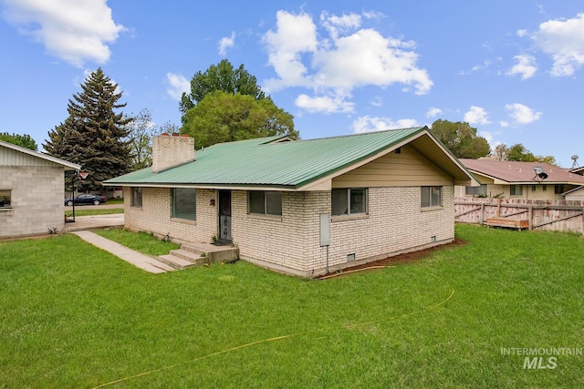 1006 S B St, Rupert, ID 83350 - rear view of house featuring brick siding, crawl space, and metal roof