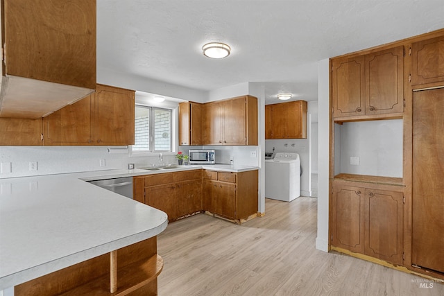 1006 S B St, Rupert, ID 83350 - kitchen with washer / clothes dryer, appliances with stainless steel finishes, brown cabinetry, and light wood-style floors
