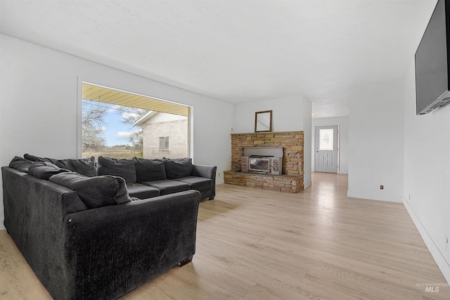 1006 S B St, Rupert, ID 83350 - living area with plenty of natural light, light wood-type flooring, a fireplace, and baseboards
