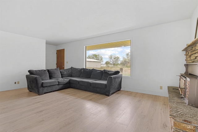 1006 S B St, Rupert, ID 83350 - living area with light wood finished floors, baseboards, and a fireplace with raised hearth