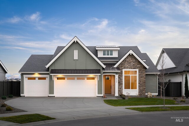 4364 N Madden Way, Meridian, ID 83646 - view of front facade with board and batten siding, a garage, stone siding, fence, and driveway