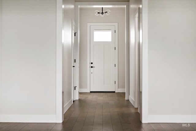 4364 N Madden Way, Meridian, ID 83646 - hallway featuring dark wood-type flooring, a notable chandelier, and baseboards