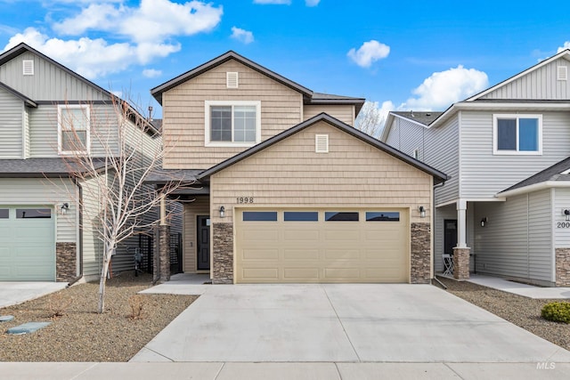 craftsman inspired home with concrete driveway, a garage, and stone siding