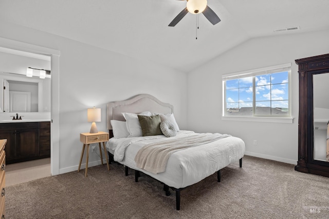 bedroom with lofted ceiling, carpet, baseboards, and a sink