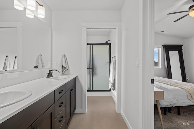 ensuite bathroom featuring visible vents, a shower stall, ceiling fan, and a sink