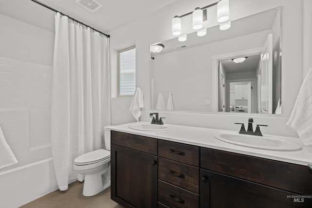 bathroom featuring double vanity, visible vents, toilet, and a sink