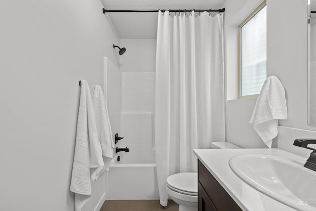 full bath featuring shower / bathtub combination with curtain, toilet, and vanity