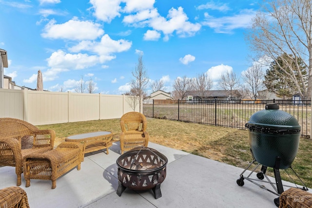 view of patio featuring a fire pit, area for grilling, and a fenced backyard