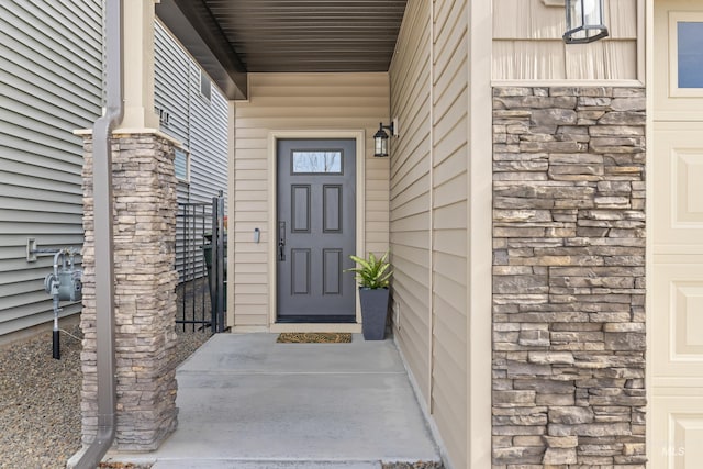 doorway to property with stone siding