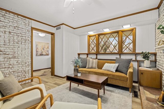 living room featuring ceiling fan, light hardwood / wood-style flooring, and crown molding