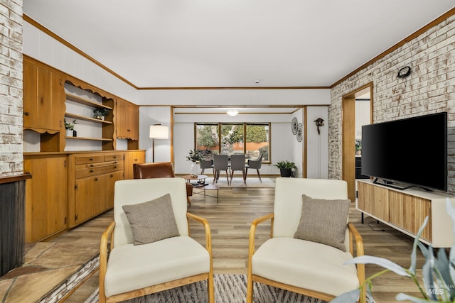 living room with light wood-type flooring and crown molding