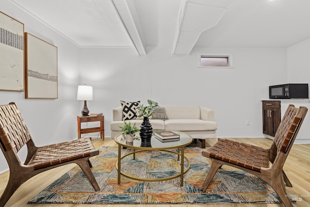 living room with hardwood / wood-style floors and beamed ceiling