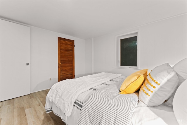 bedroom with a closet and light hardwood / wood-style flooring