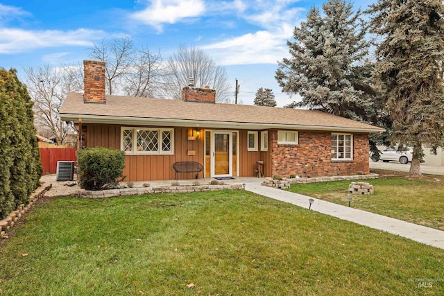 ranch-style home with cooling unit and a front lawn