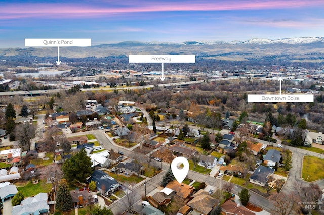 aerial view at dusk featuring a mountain view