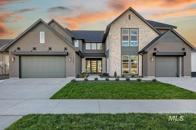 view of front of house featuring a yard and a garage