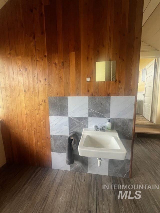 2070 Woodland Rd, Kamiah, ID 83536 - bathroom featuring wood finished floors, wood walls, and a sink