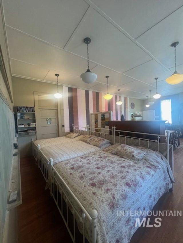 2070 Woodland Rd, Kamiah, ID 83536 - bedroom with dark wood-type flooring, wallpapered walls, and attic access
