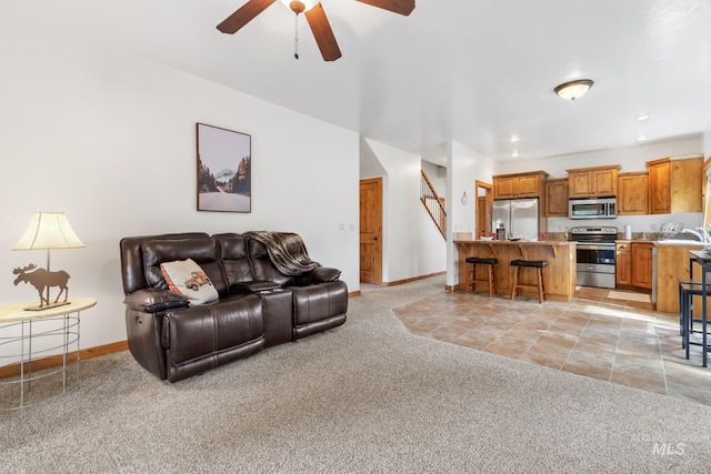 living room featuring light carpet, ceiling fan, recessed lighting, and baseboards