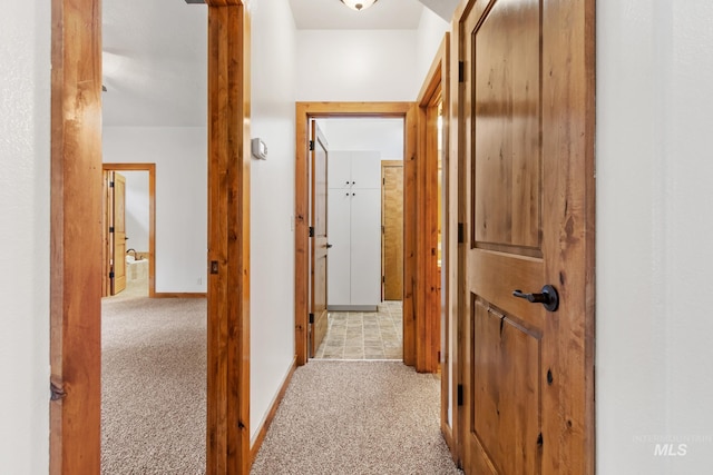 hall featuring carpet floors and baseboards