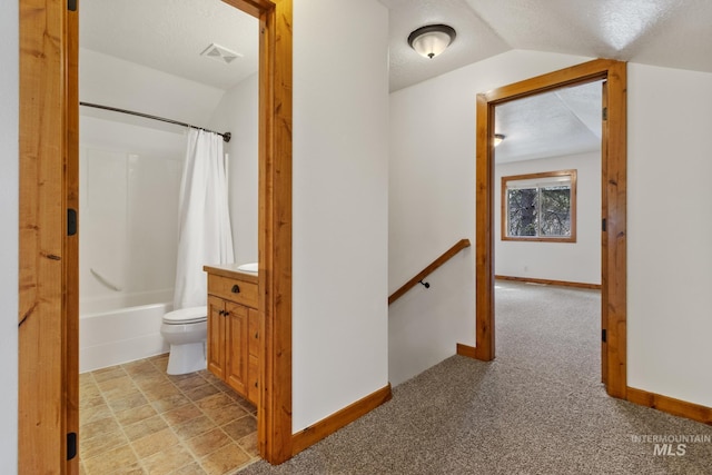 corridor featuring visible vents, vaulted ceiling, a textured ceiling, an upstairs landing, and baseboards