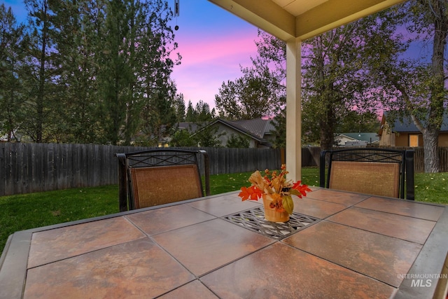 view of patio with outdoor dining space and a fenced backyard