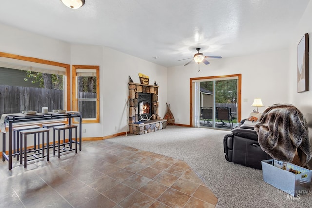 living room featuring carpet floors, ceiling fan, and baseboards