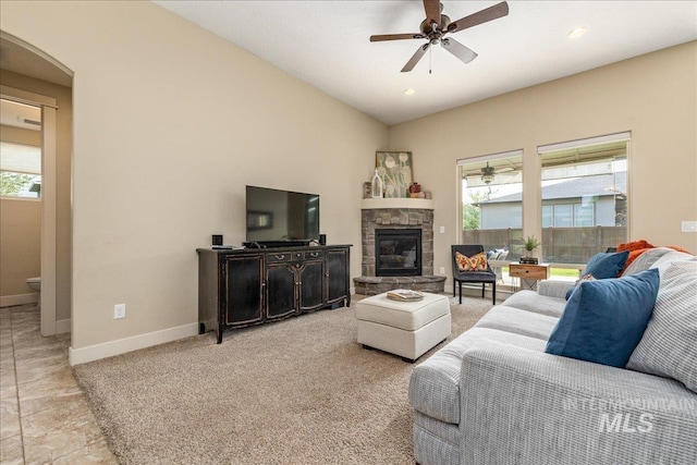 living room featuring light carpet, ceiling fan, and a healthy amount of sunlight