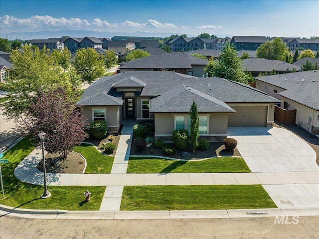 view of front of home featuring a garage and a front yard