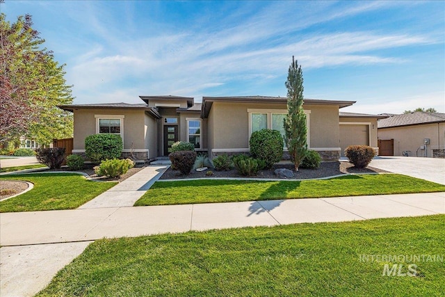 prairie-style house with a garage and a front yard