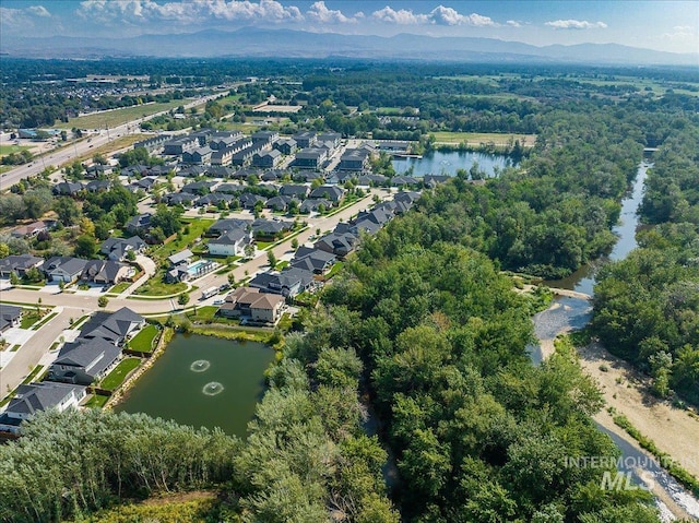 birds eye view of property with a water and mountain view