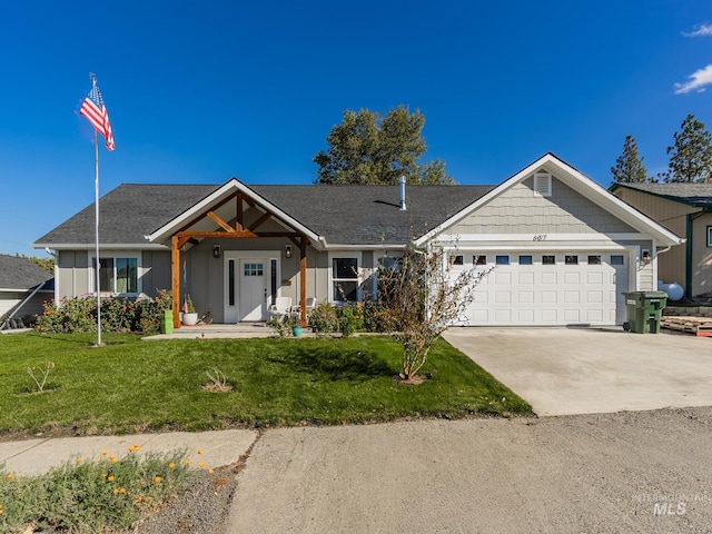 view of front of house featuring a garage and a front yard