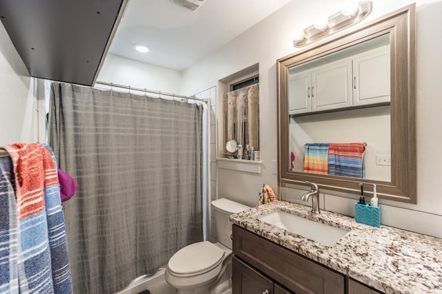 bathroom featuring vanity, toilet, and a shower with curtain