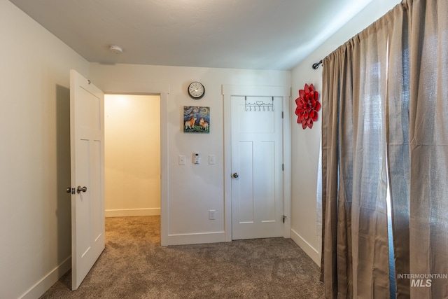 interior space with dark colored carpet