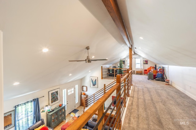 interior space featuring carpet, lofted ceiling with beams, and ceiling fan