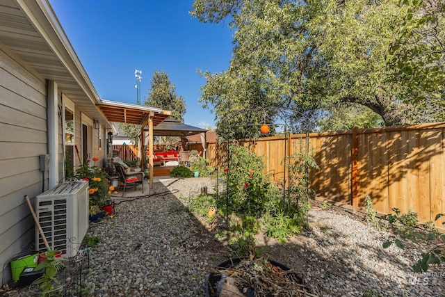 view of yard with ac unit and a patio