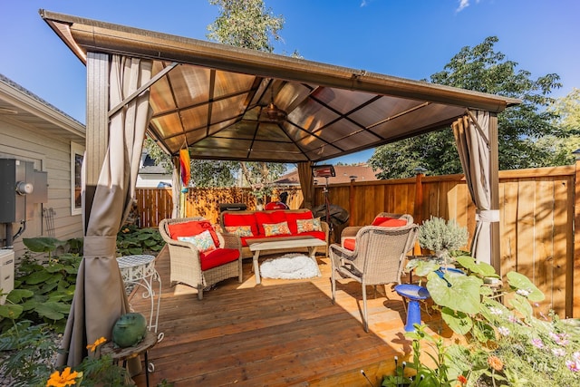 wooden deck with an outdoor living space and a gazebo