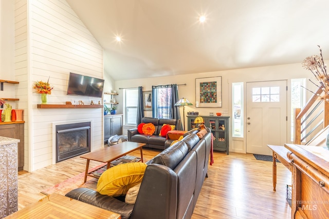 living room with lofted ceiling and light hardwood / wood-style flooring