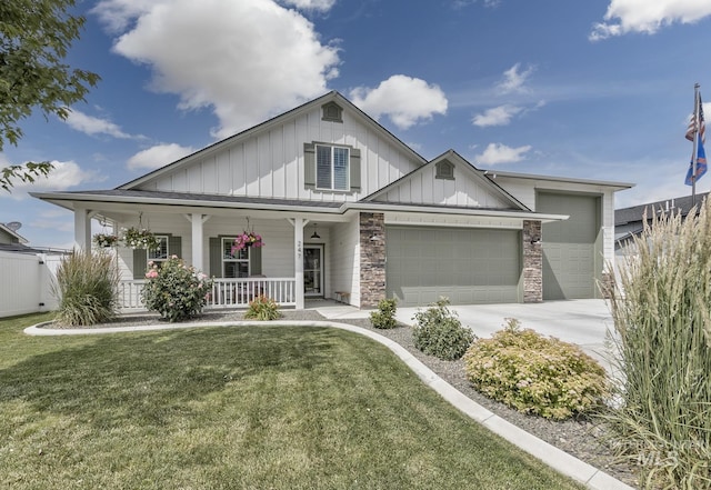 247 Stagecoach Ave, Fruitland, ID 83619 - view of front of property with board and batten siding, a porch, an attached garage, and a front yard