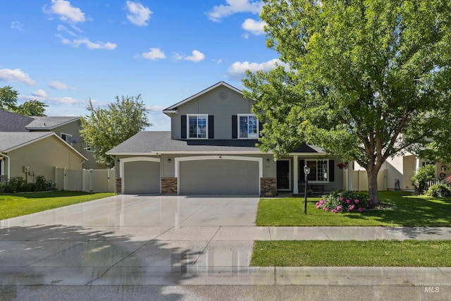 2145 W Quilceda, Kuna, ID 83634 - view of front of house with driveway, stone siding, and an attached garage