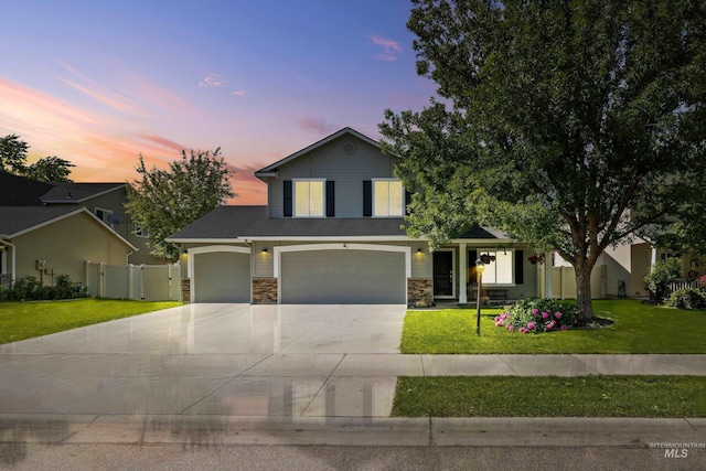 2145 W Quilceda, Kuna, ID 83634 - view of front facade featuring stone siding, driveway, an attached garage, and a garage